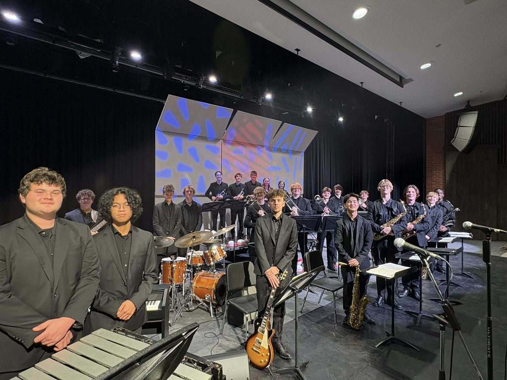 The students who make up Lincoln High School's Jazz Collective pose on the stage with their instruments ready to perform
