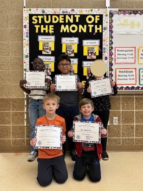 first grade students of the month holding their certificates