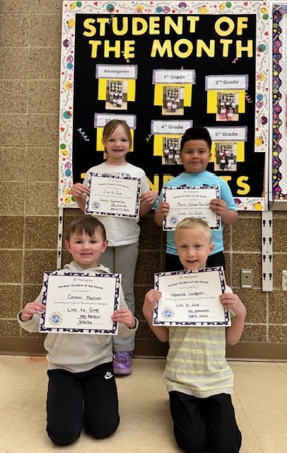 Kindergarten students of the month holding their certificates