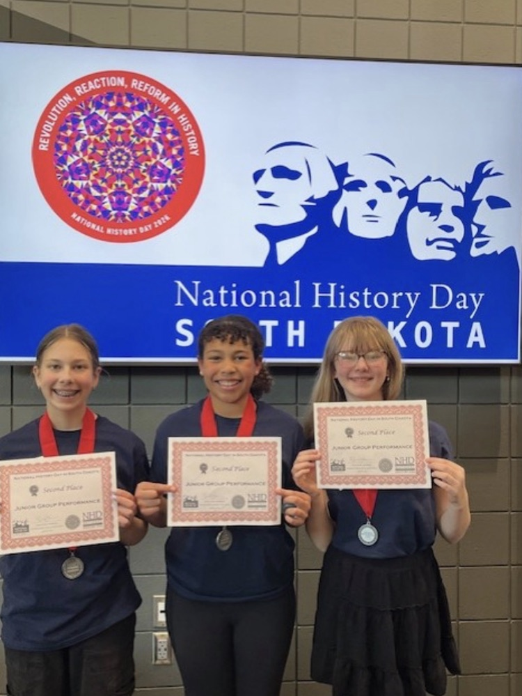 3 students in front of a national history day sign 