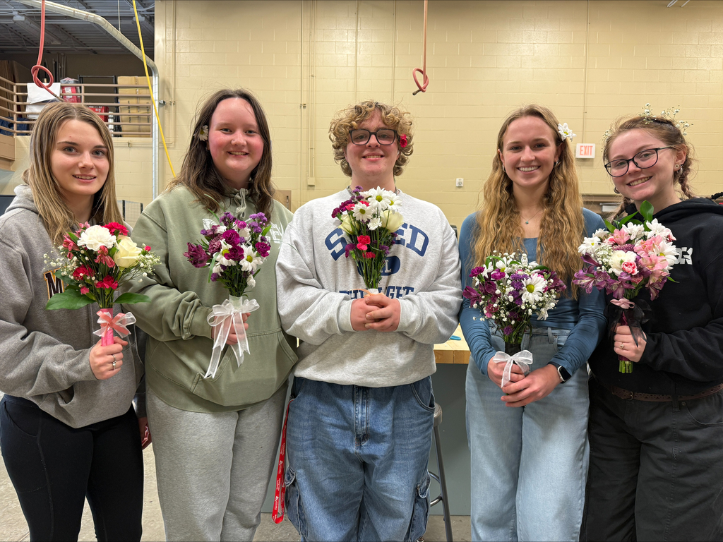 Horticulture students posing with their flower arrangements