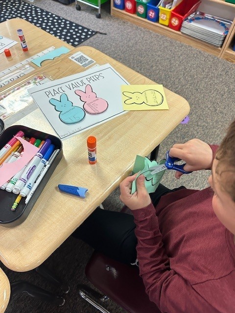 student cutting out peep shape