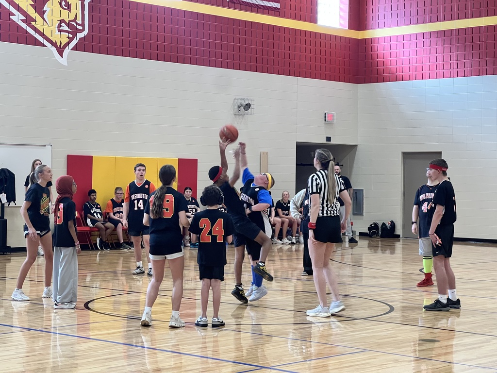 Members of the Ben Reifel Unity Team and the Washington High School Best Buddies team stand in the middle of the court eagerly as they await the first toss.