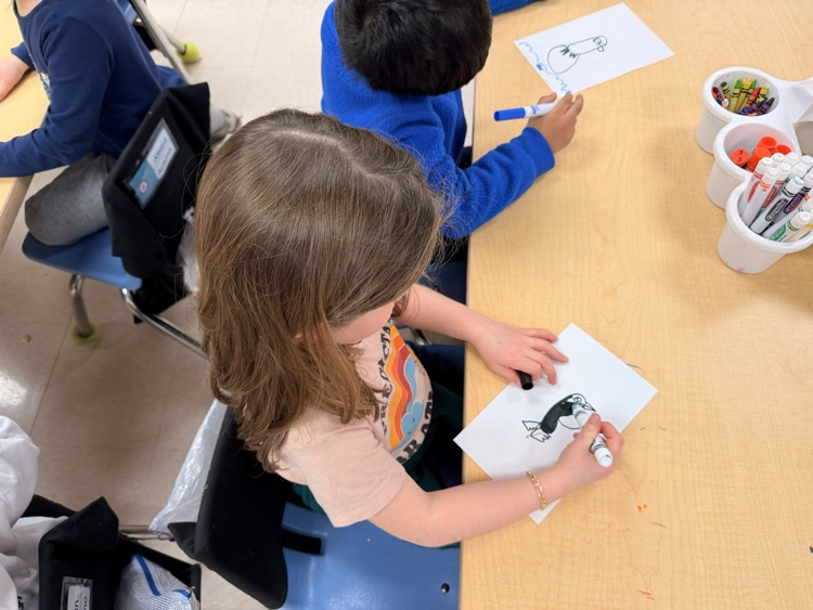 two students writing/drawing 