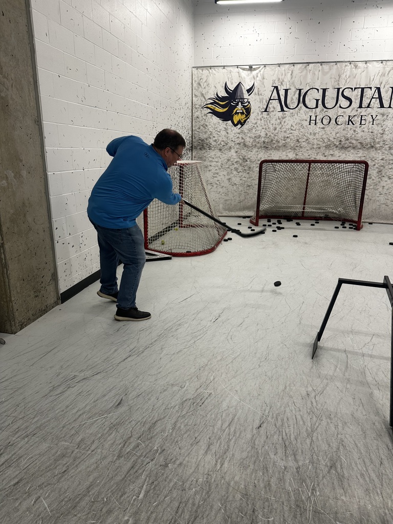 Teacher Mr. Feuerstein attempting his career at hockey