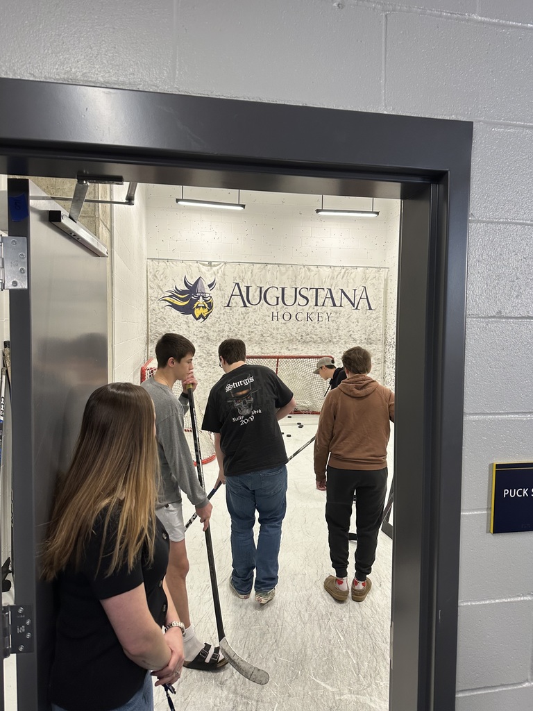 students practicing hitting a puck into the goal  in the Puck Shot room