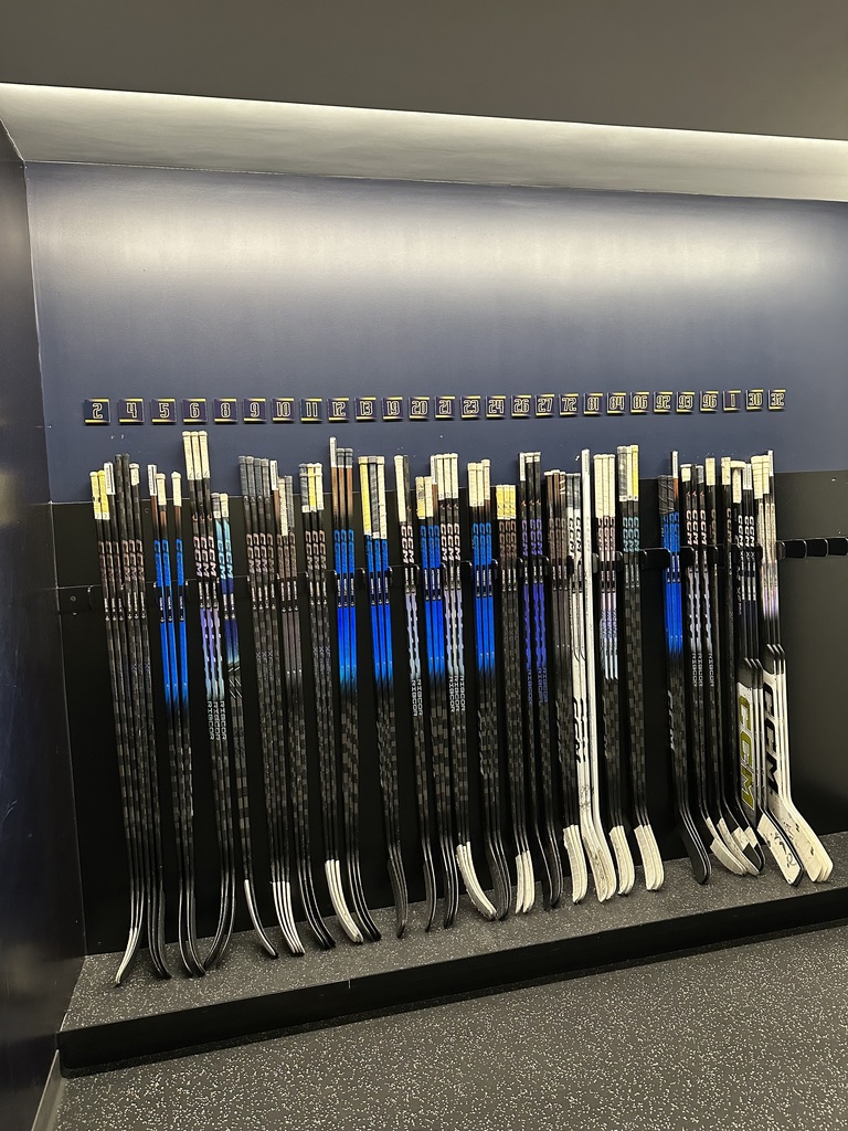 Line up of hockey sticks