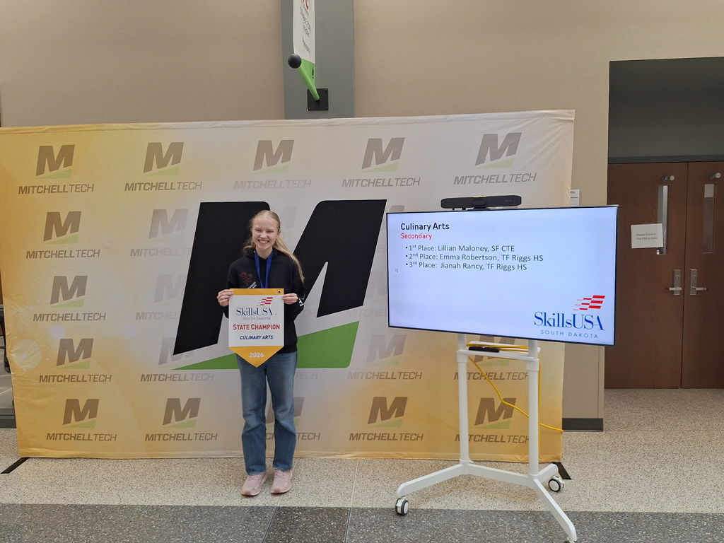 CTE student posing with her award