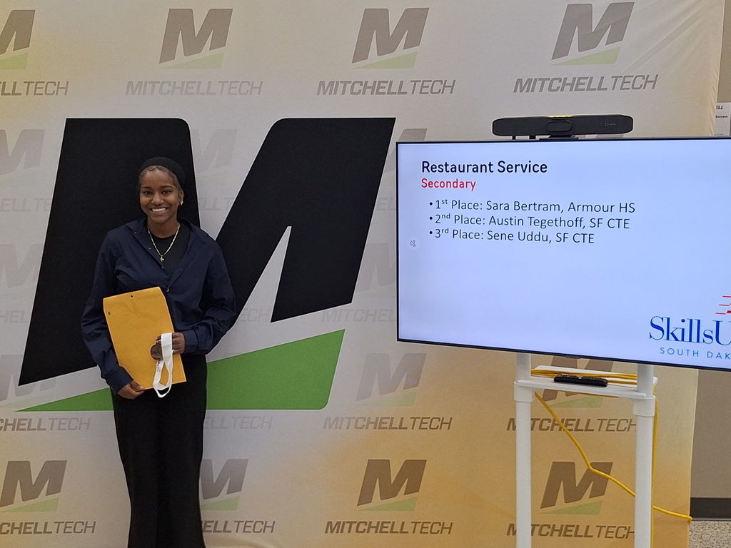 CTE student posing with her award