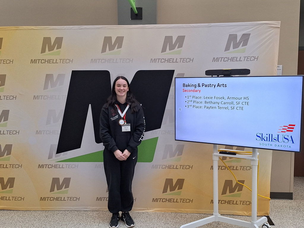 CTE student posing with her award