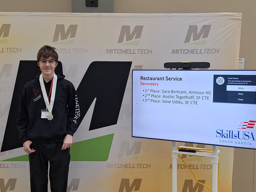 CTE student posing with his award