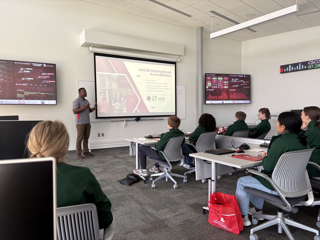 Students in a classroom listening to the guest speaker