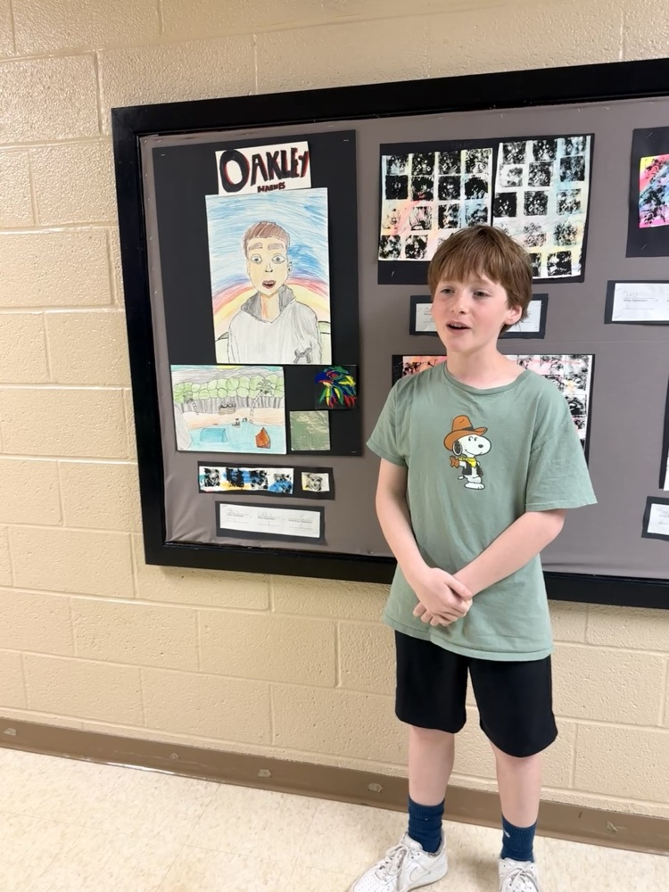 student standing in front of artwork 