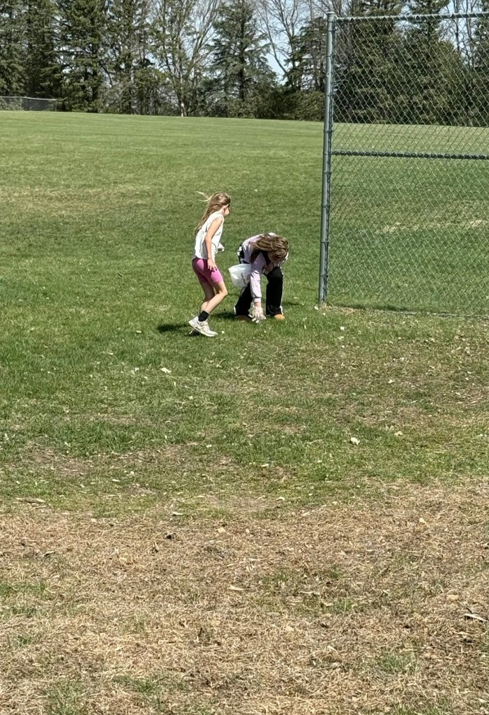 2 girls picking up garbage