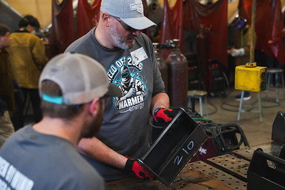 Instructor inspecting the welds