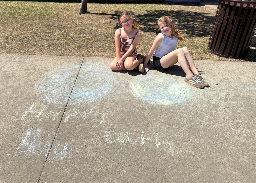 Students drawing with outside chalk. 
