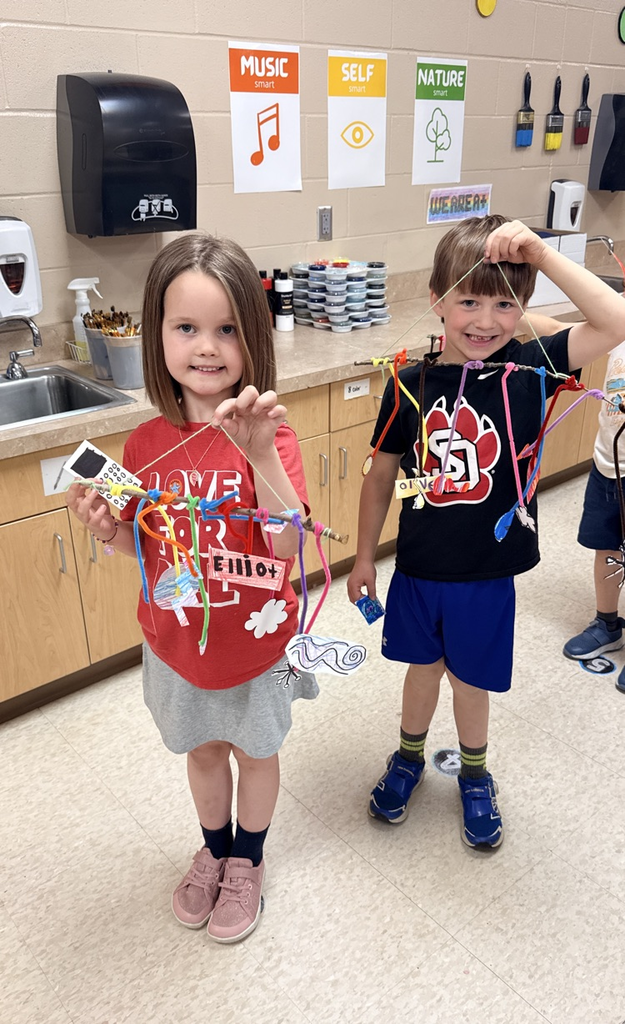 2 kindergartners holding mobiles 