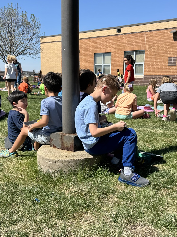 students using a picnic on the Pettigrew front lawn