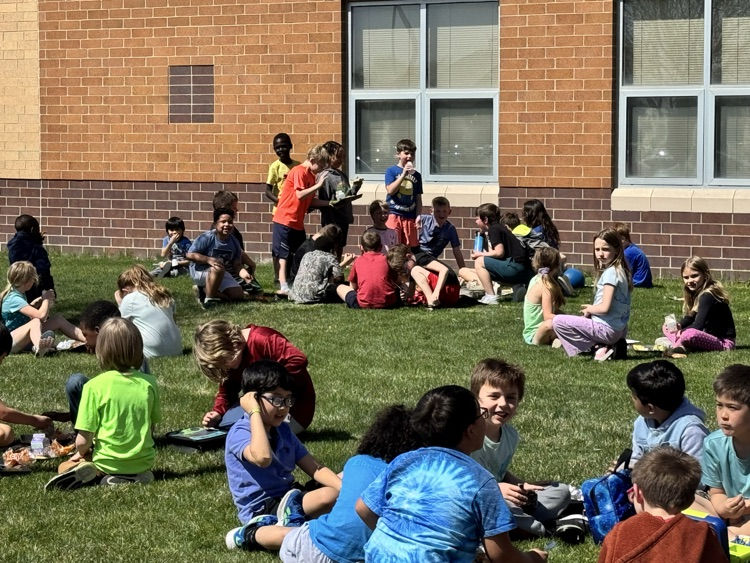 students using a picnic on the Pettigrew front lawn