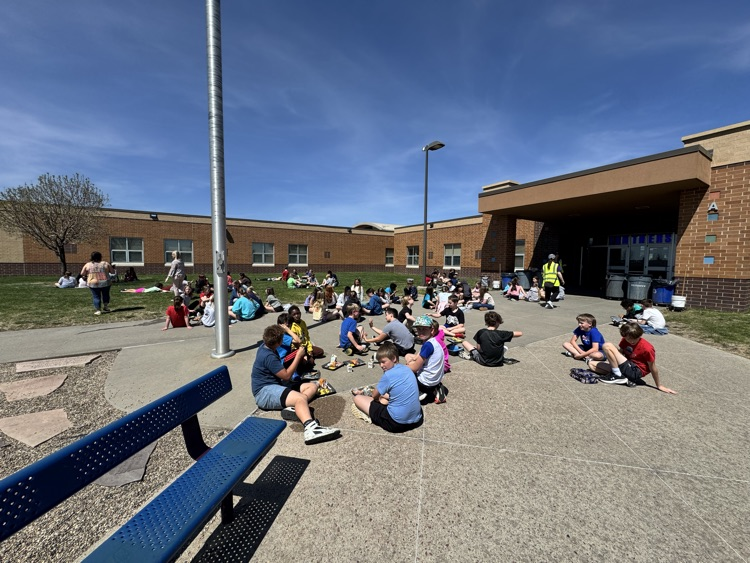 students using a picnic on the Pettigrew front lawn