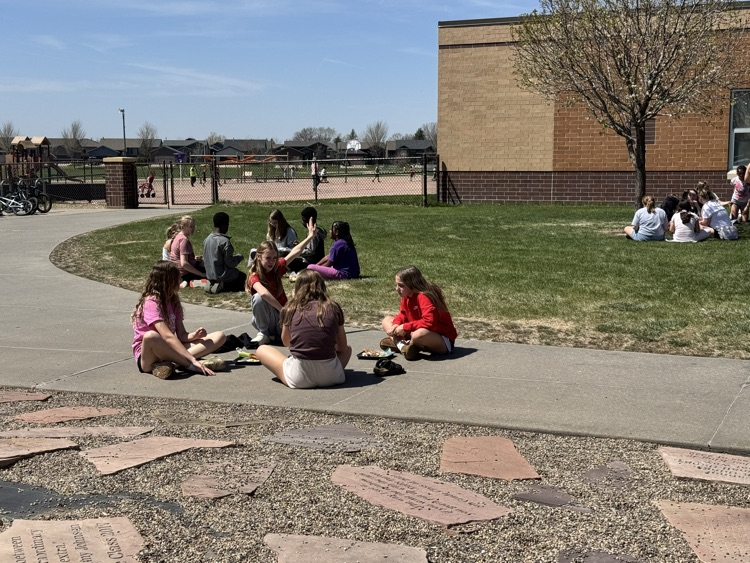students using a picnic on the Pettigrew front lawn
