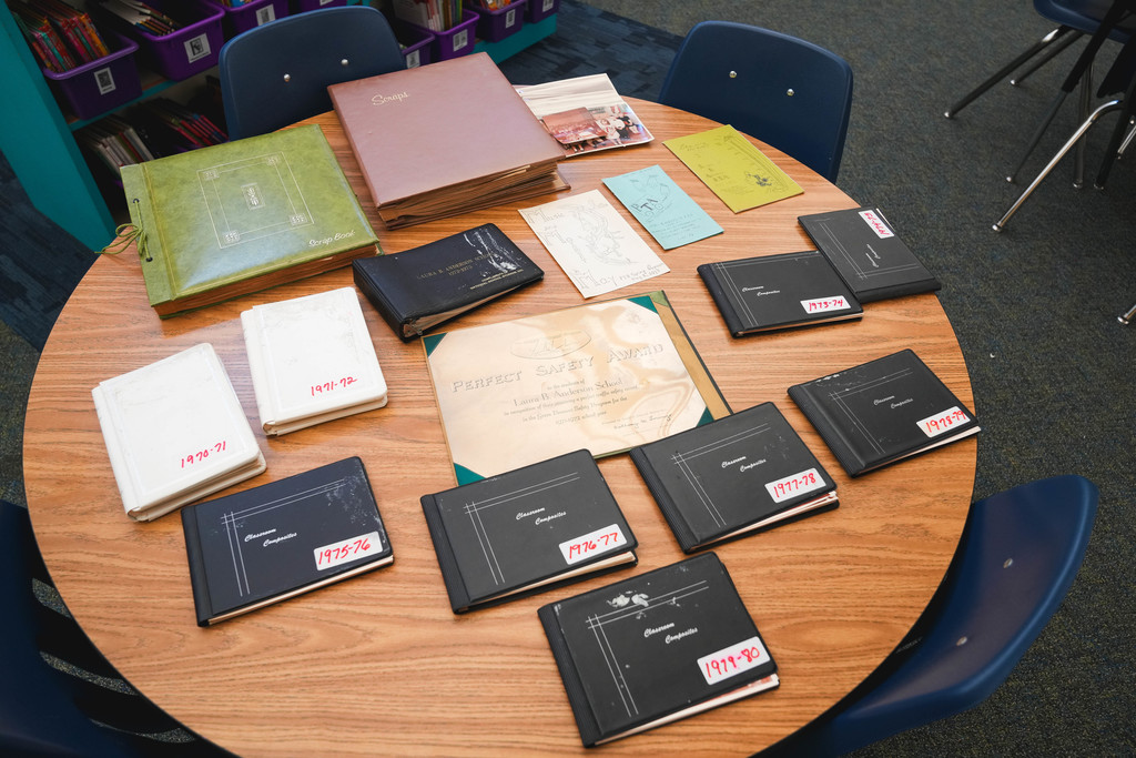 Old photo albums sit unopened on a table