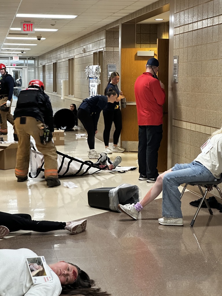 student volunteers injured in a hallway while first responders are rescuing them