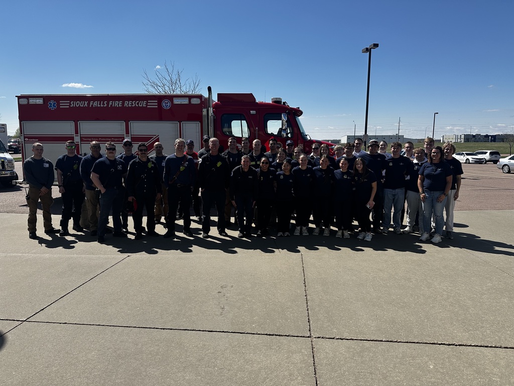 EMT students with first responders for a photo