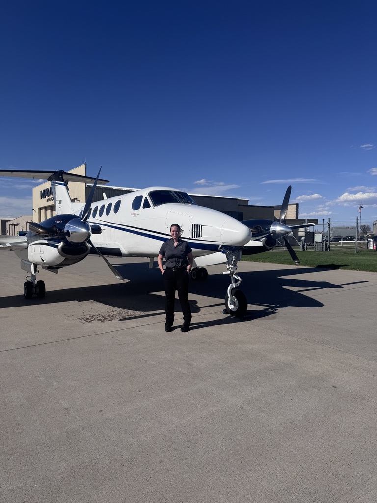 Isabel posing in front of a plane