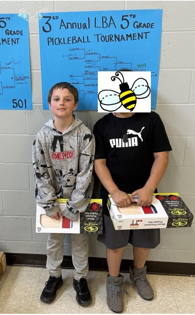 boys standing in front of a tournament bracket