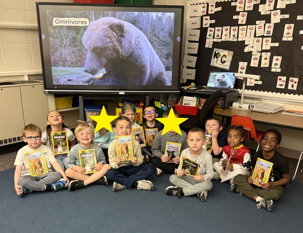 All of K01 students holding books about animals.