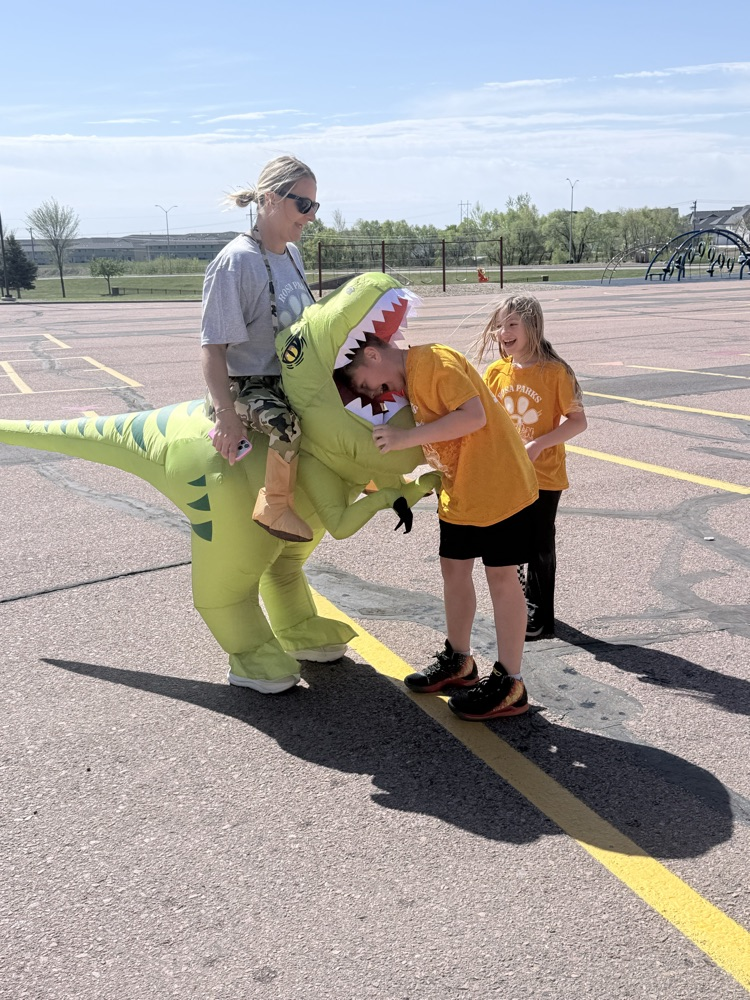 a staff member and students at the Fun Run