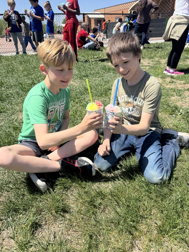 two students enjoying snow cones 