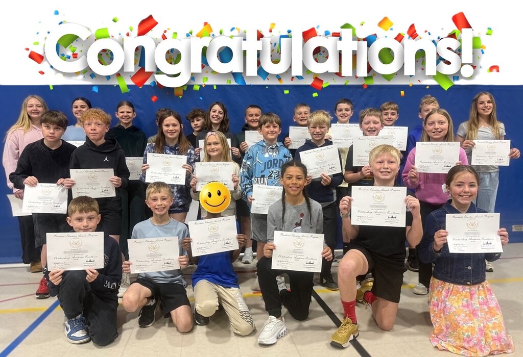 Students holding certificates.