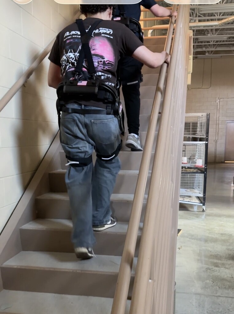 AOF students trying out the exoskeleton