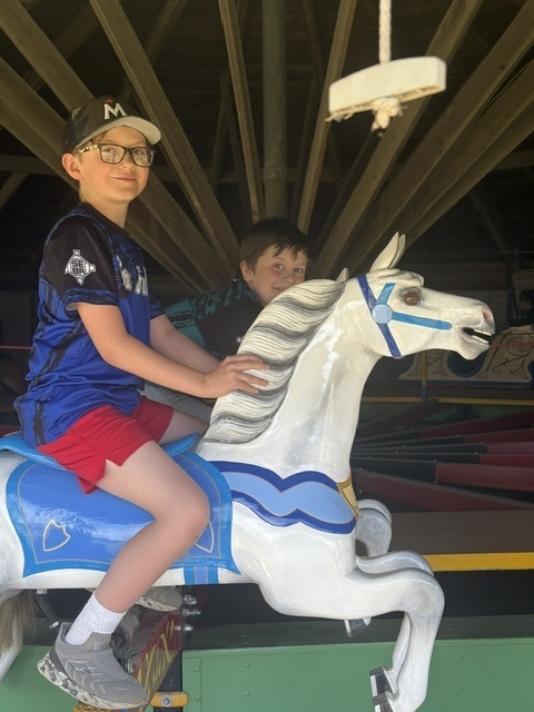 2 boys on a carousel