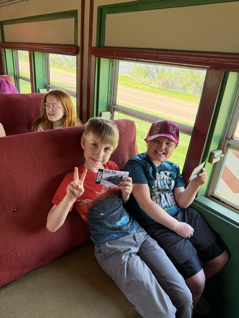 2 boys on a train with tickets