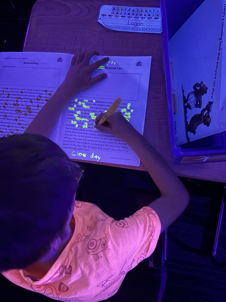 student doing a writing lesson with glowing markers