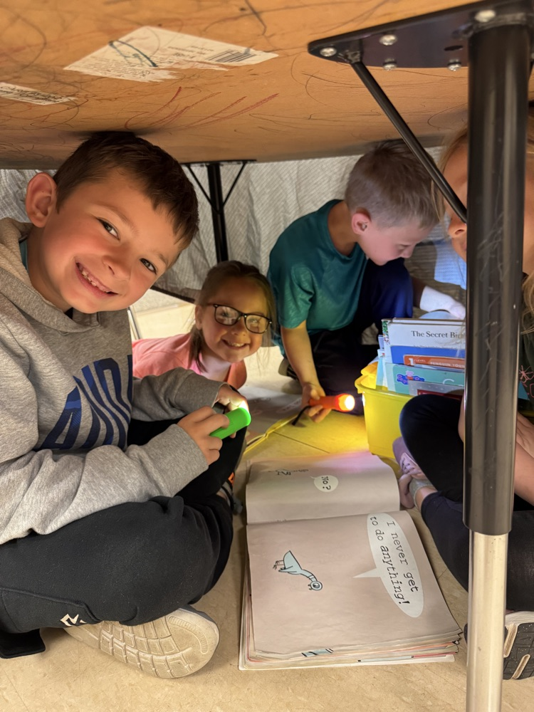 students camping in their classroom