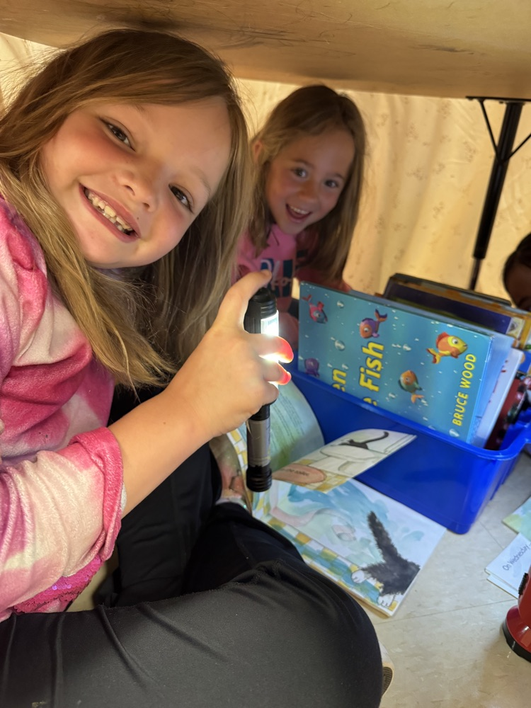 students camping in their classroom