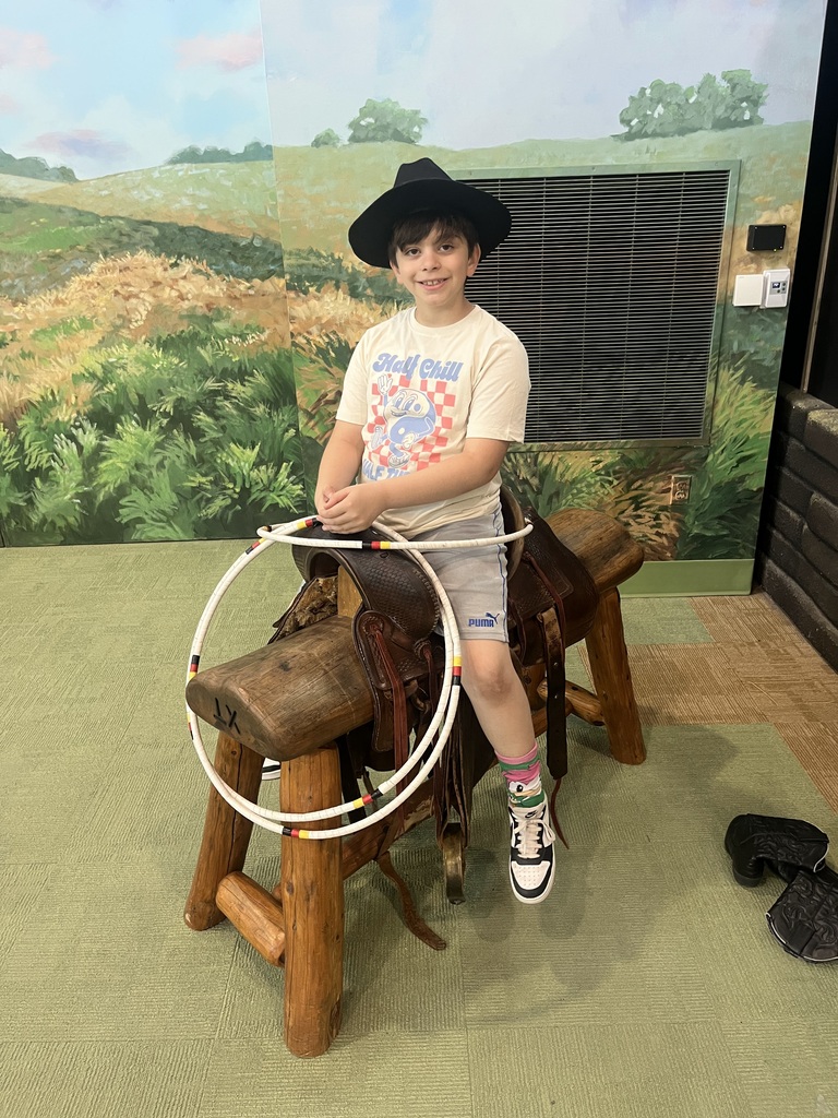 boy sitting on a saddle
