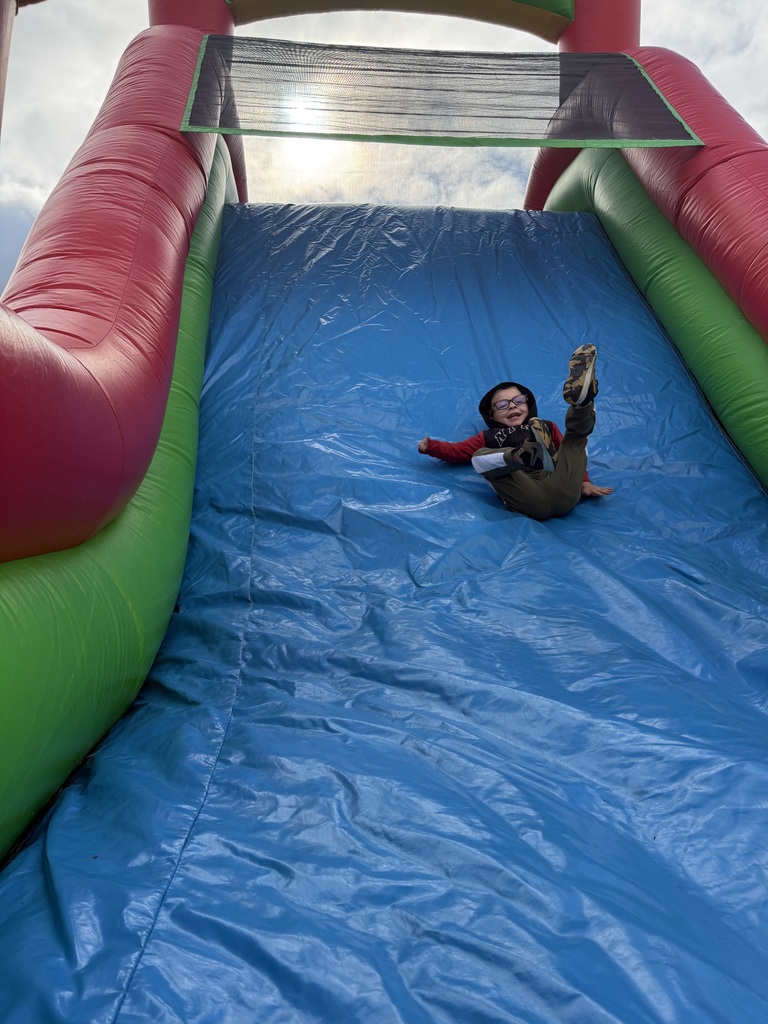 boy coming down the inflatible slide