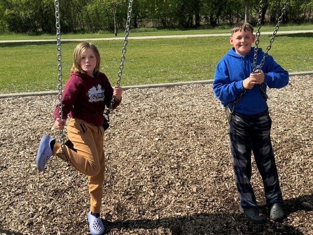 Two students on swings.