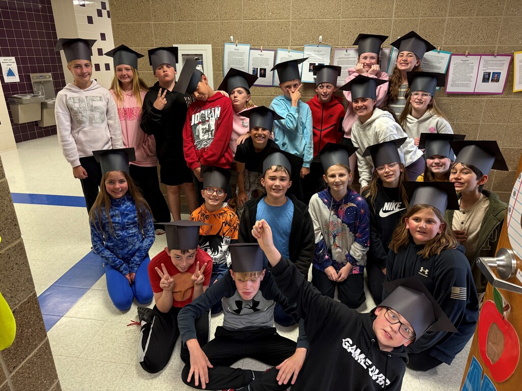 Students wearing graduation outfit.