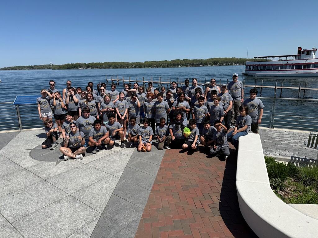 group of students in front of a lake