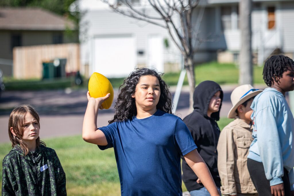 boy throwing a football