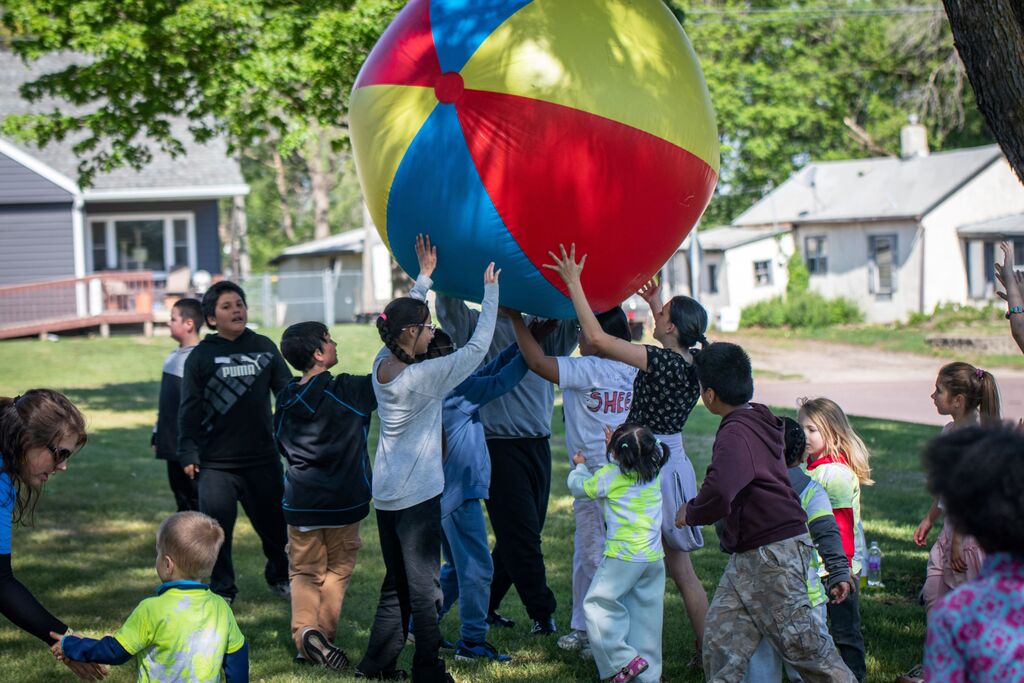 students playing with a large ball