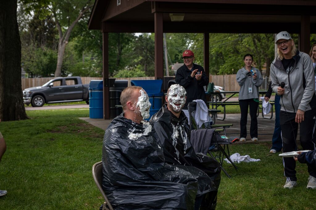 people with whipped cream on their face