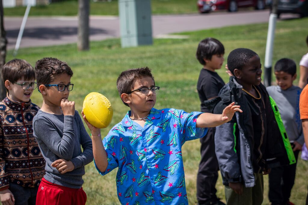 boy throwing a football