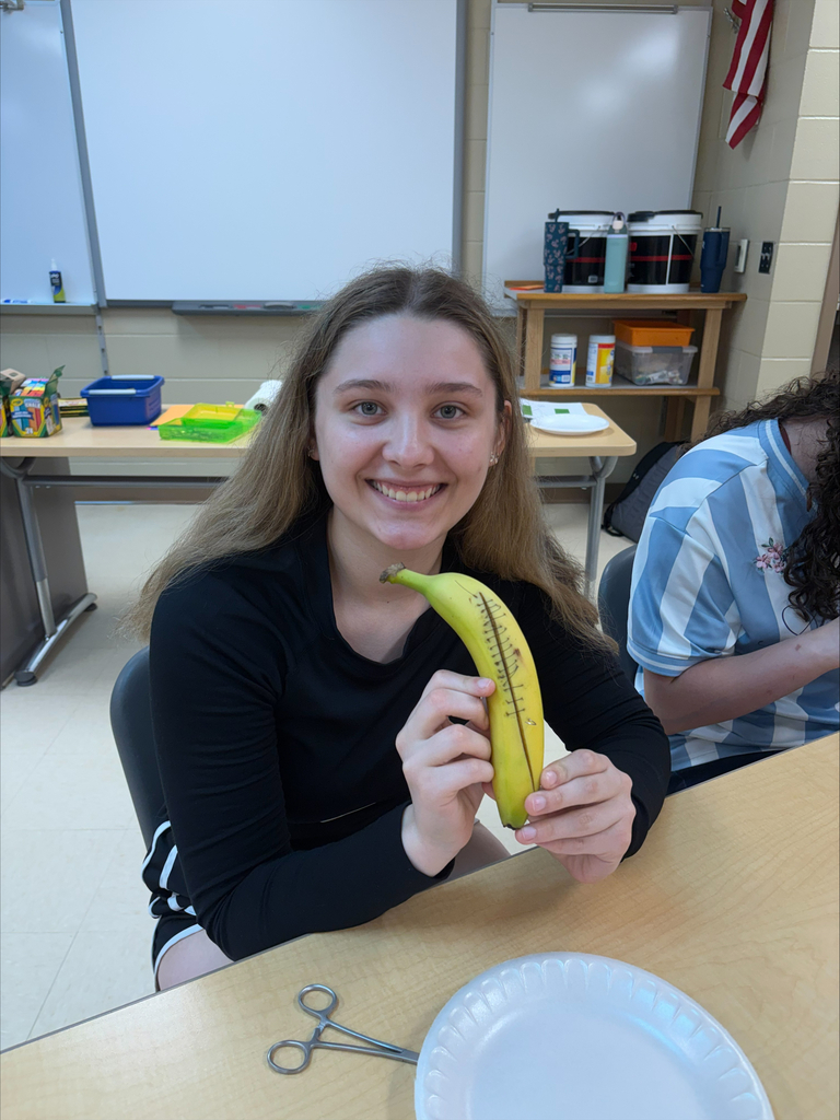 Student showing her work in stitching a banana